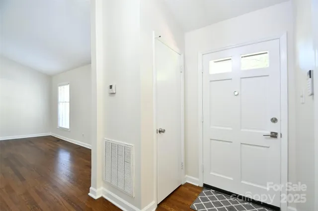 a bedroom with a bed and a potted plant