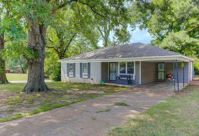 a front view of a house with a garden and porch