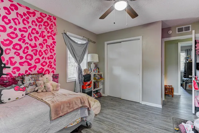 a bedroom with a bed and a chandelier