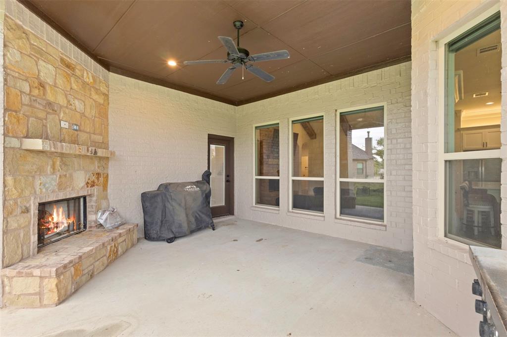 105 Clayton Crossing Springtown, TX 76082 - Photo 28 of 40 a view of an empty room with a fireplace and a window