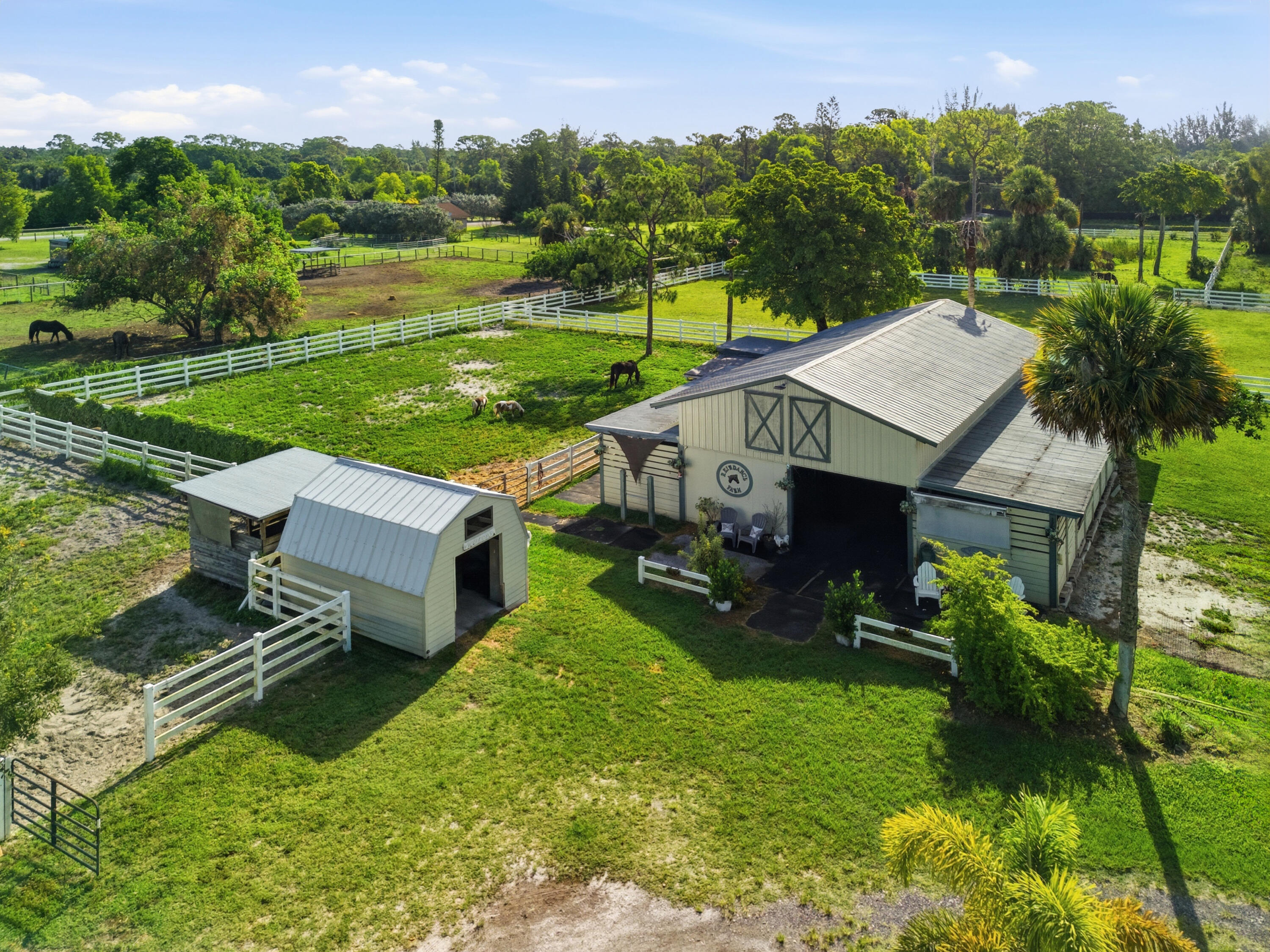14095 Biddex Road Loxahatchee Groves, FL 33470 - Photo 34 of 69 an aerial view of a house with pool garden and mountain view in back