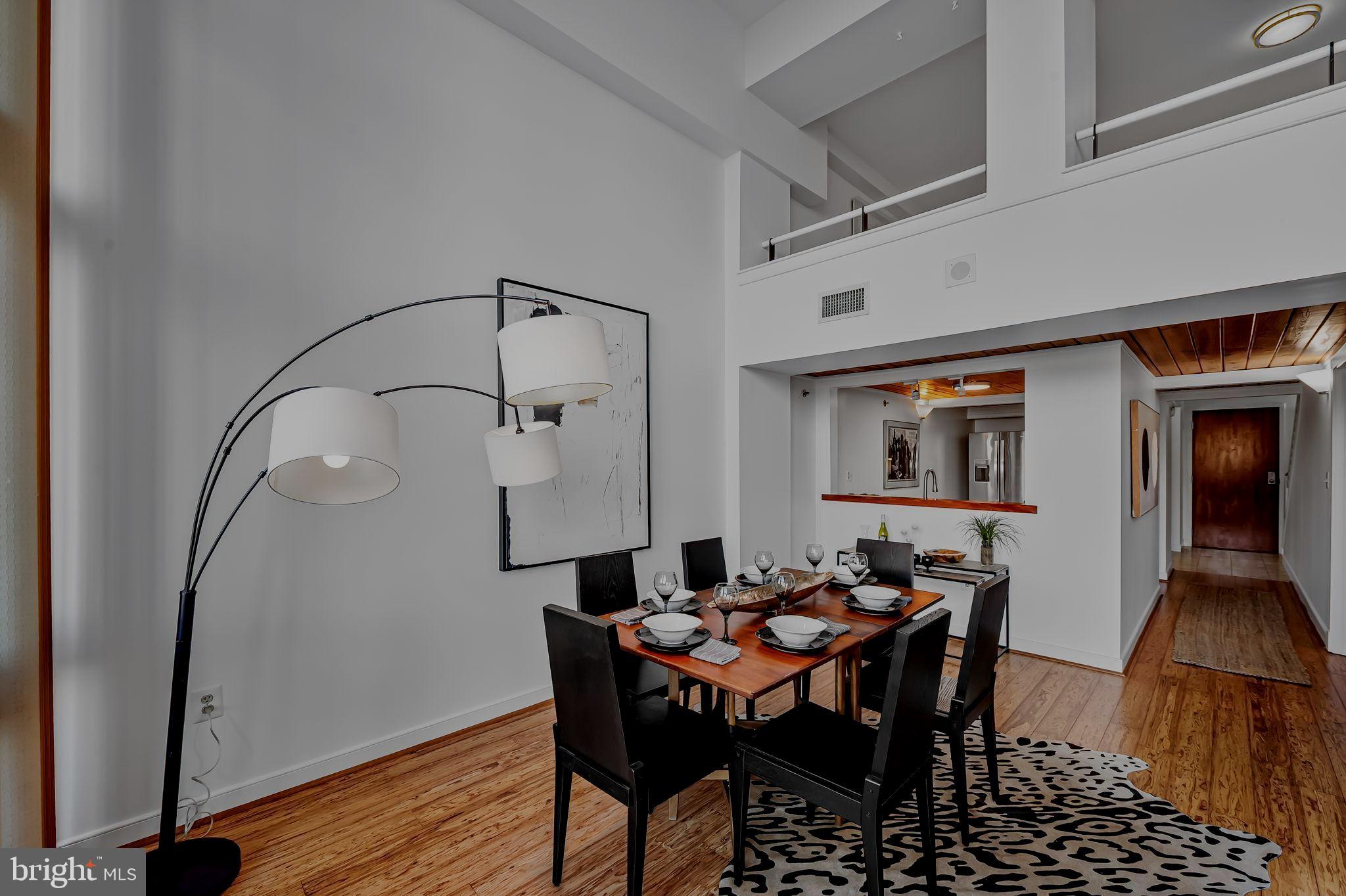 2901 Boston Street, Unit 204 Baltimore, MD 21224 - Photo 14 of 60 a dining room with furniture and wooden floor