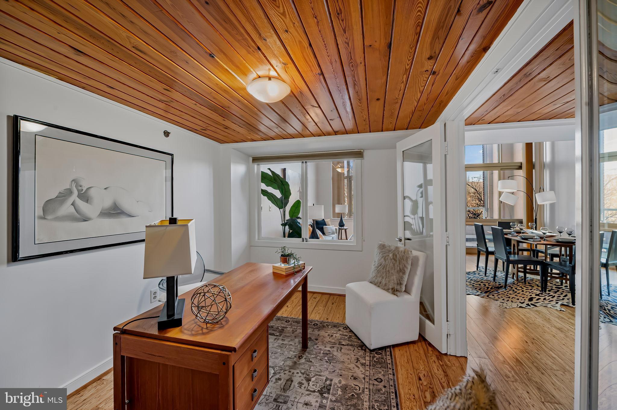 2901 Boston Street, Unit 204 Baltimore, MD 21224 - Photo 17 of 60 a living room with furniture and a potted plant