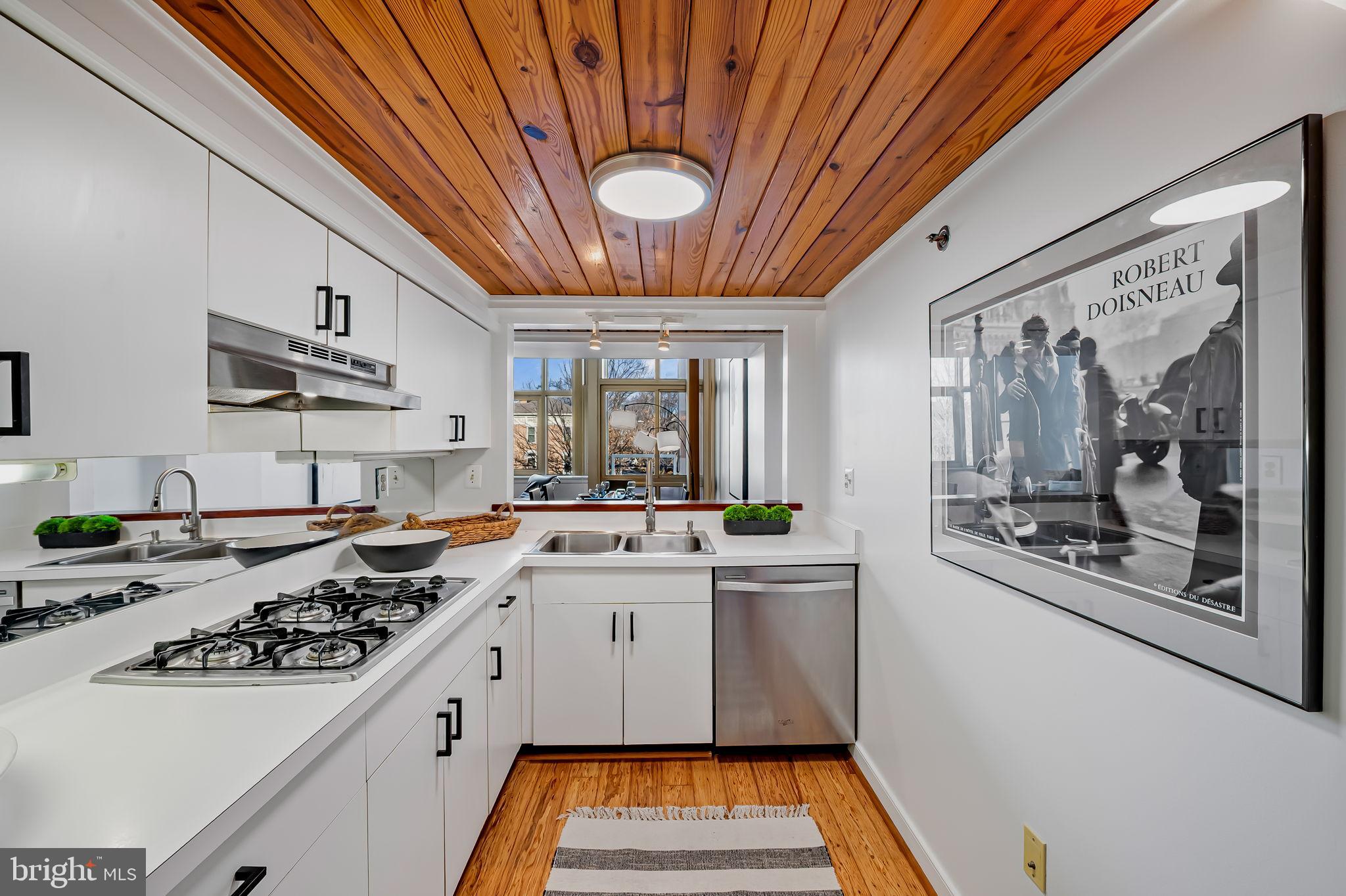 2901 Boston Street, Unit 204 Baltimore, MD 21224 - Photo 18 of 60 a kitchen with a sink a stove and cabinets