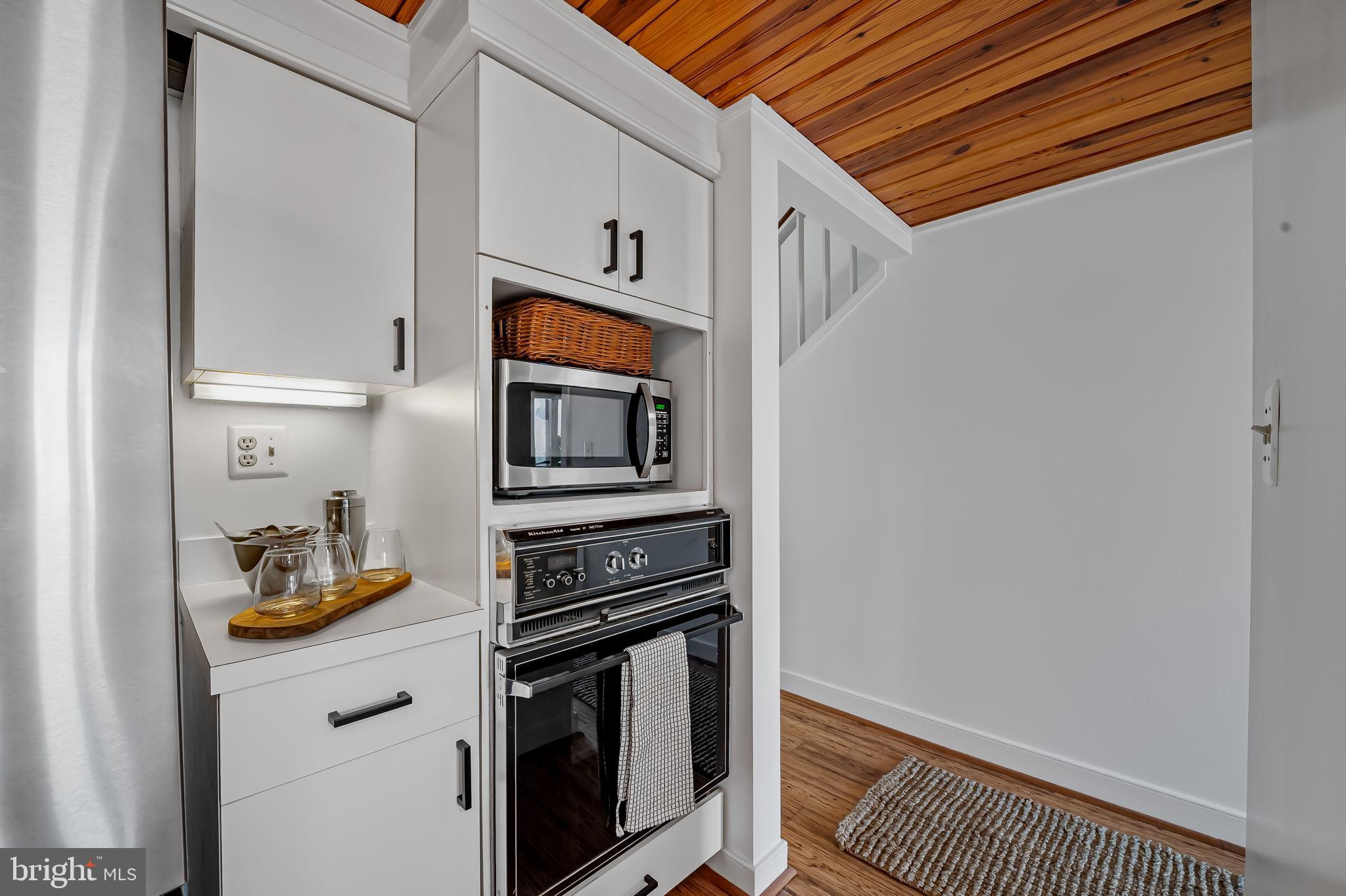 2901 Boston Street, Unit 204 Baltimore, MD 21224 - Photo 22 of 60 a kitchen with stainless steel appliances a refrigerator and a stove top oven