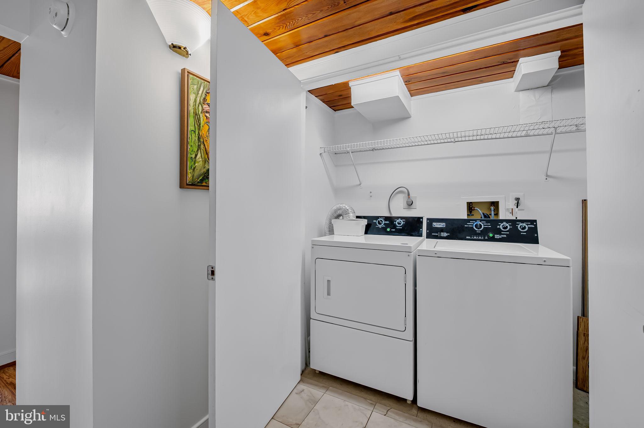 2901 Boston Street, Unit 204 Baltimore, MD 21224 - Photo 23 of 60 a kitchen with a refrigerator and a sink