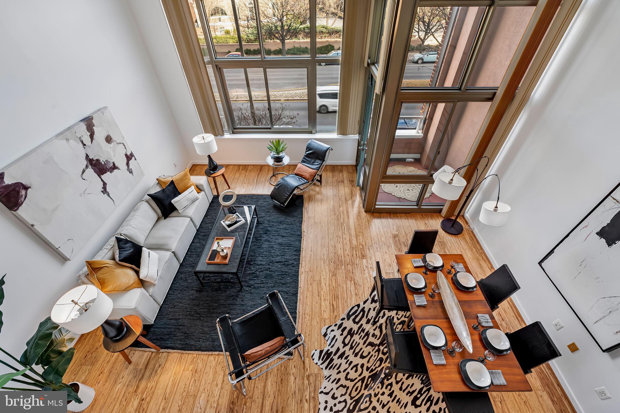 2901 Boston Street, Unit 204 Baltimore, MD 21224 - Photo 28 of 60 a living room with furniture and a floor to ceiling window