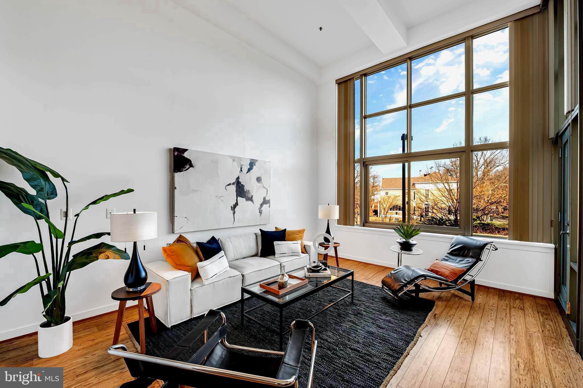 2901 Boston Street, Unit 204 Baltimore, MD 21224 - Photo 6 of 60 a living room with furniture and a wooden floor