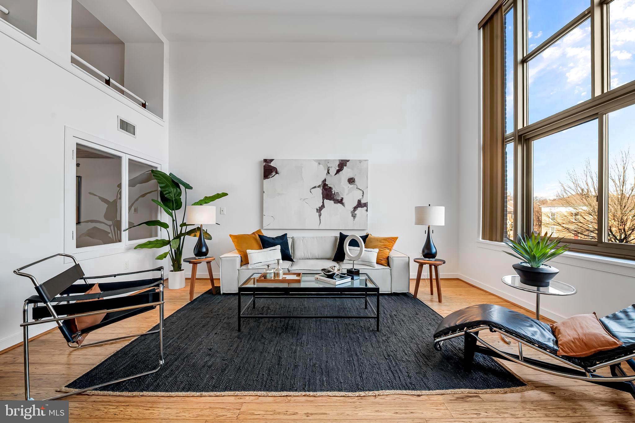 2901 Boston Street, Unit 204 Baltimore, MD 21224 - Photo 7 of 60 a living room with furniture stove and a large window
