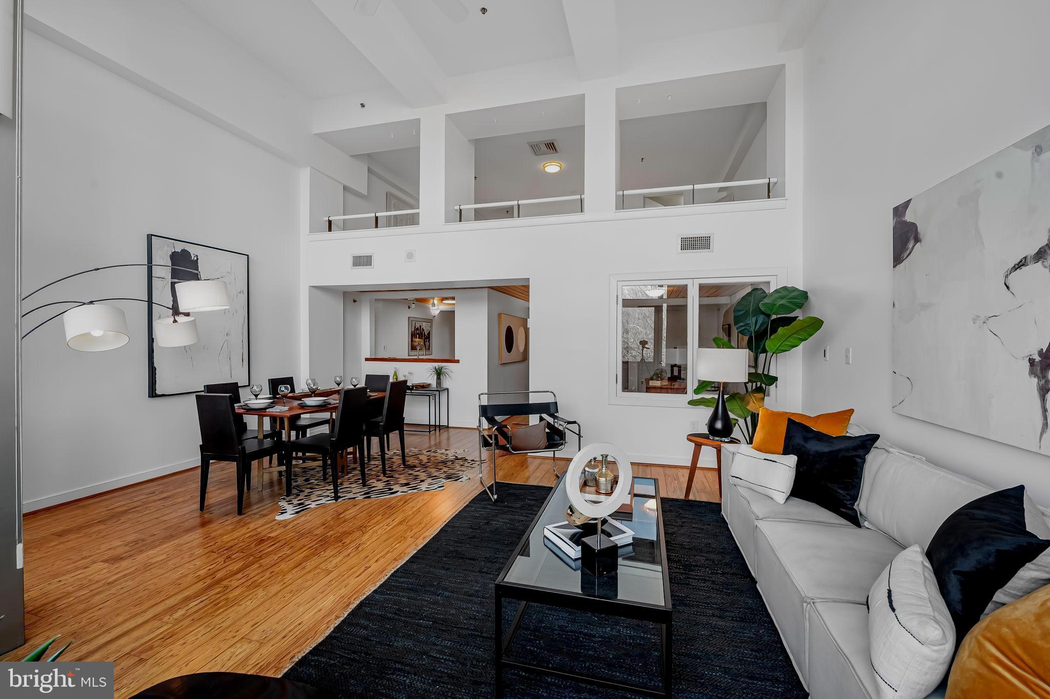 2901 Boston Street, Unit 204 Baltimore, MD 21224 - Photo 10 of 60 a living room with furniture wooden floor and dining table