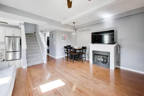 a living room with furniture a fireplace and a flat screen tv
