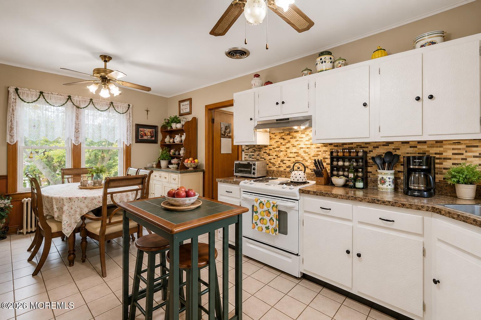24 Foster Street Middletown, NJ 07701 - Photo 6 of 23 a kitchen with stainless steel appliances kitchen island granite countertop a table chairs sink and cabinets