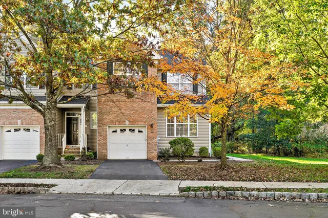a view of a white house with a tree front of it