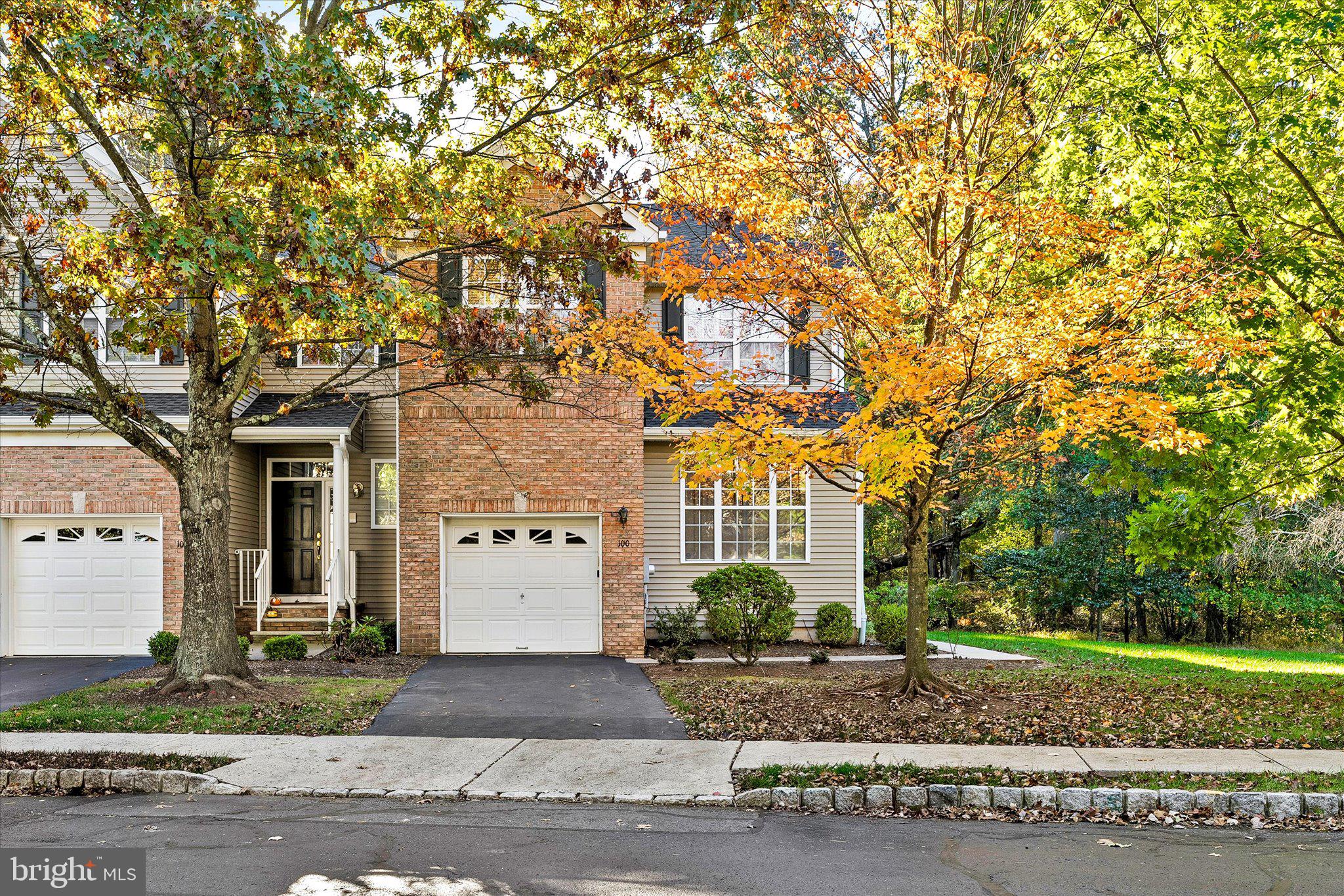 a view of a white house with a tree front of it