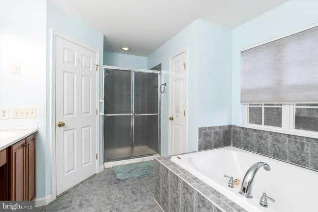 a bathroom with a tub and a shower
