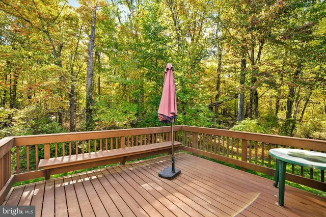 a view of wooden deck with a large window and wooden floor