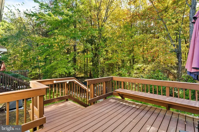 a view of a wooden deck with a yard