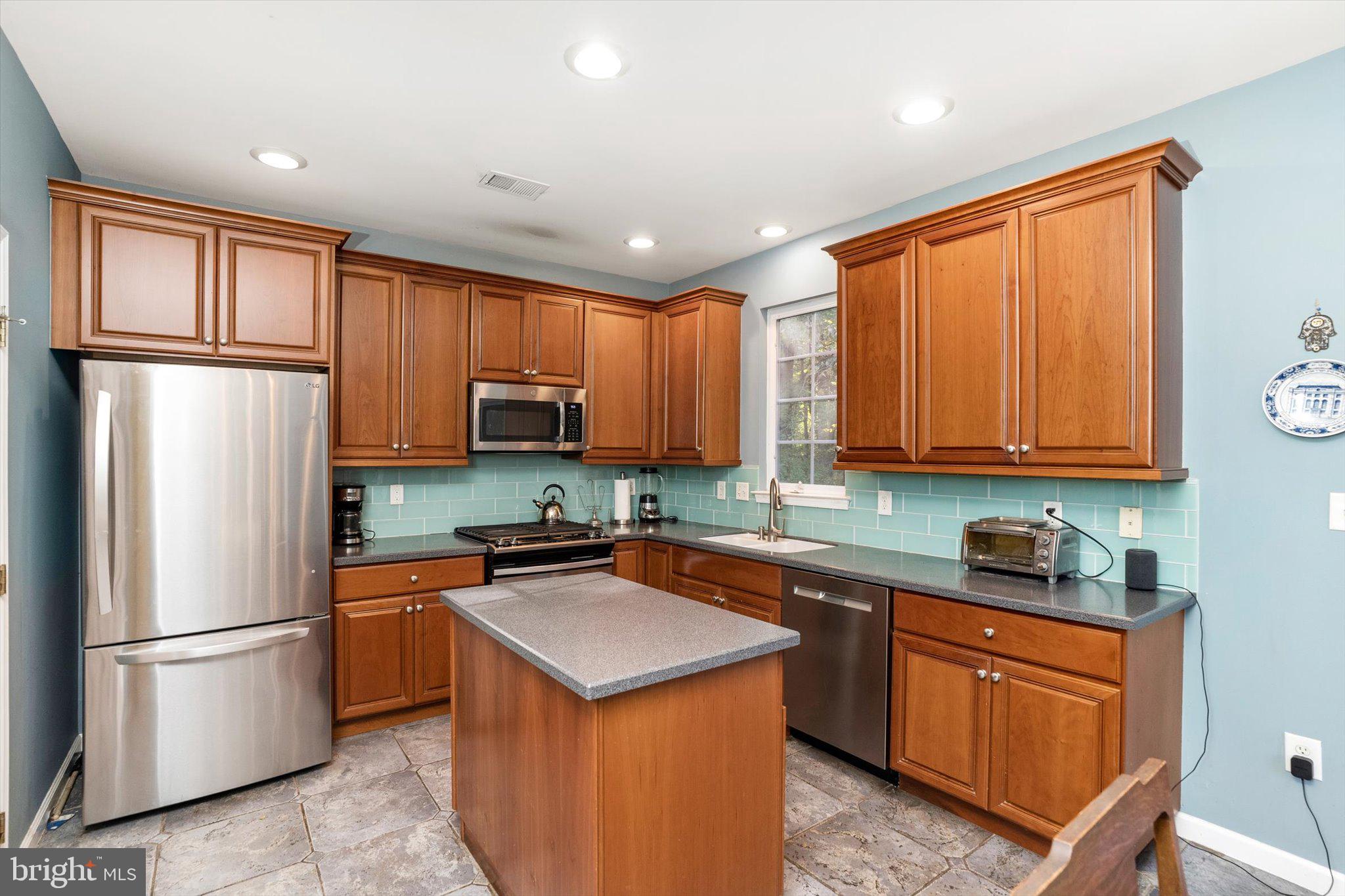 100 Jackson Avenue Princeton, NJ 08540 - Photo 7 of 33 a kitchen with stainless steel appliances granite countertop a refrigerator stove microwave and sink