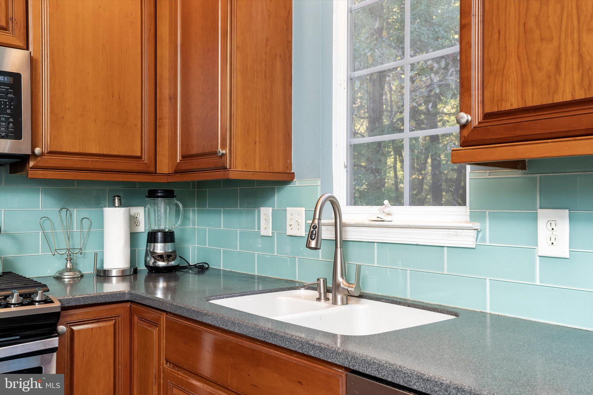 100 Jackson Avenue Princeton, NJ 08540 - Photo 9 of 33 a kitchen with stainless steel appliances granite countertop a sink a window and a counter space
