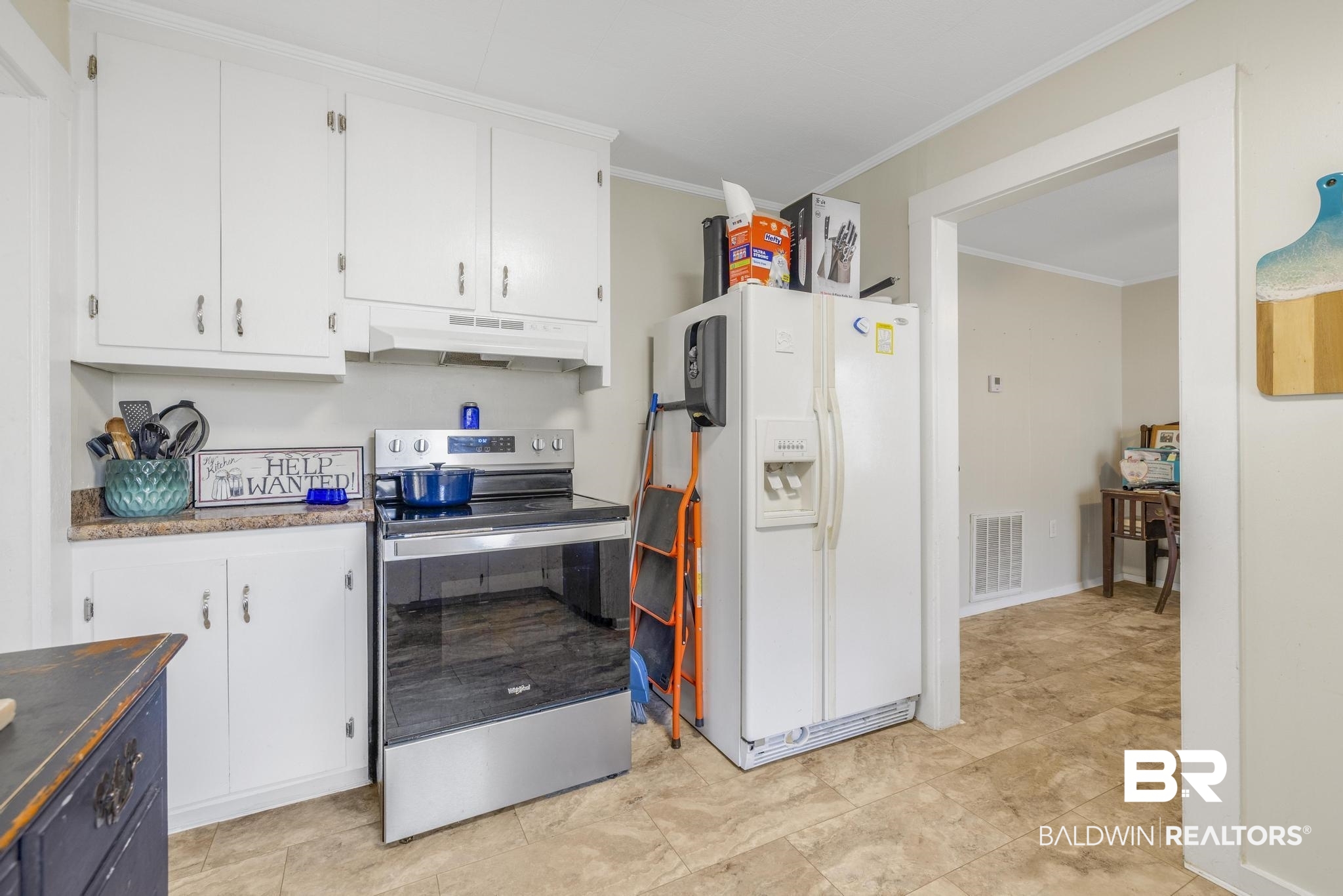 405 North Pine Street Foley, AL 36535 - Photo 21 of 33 Kitchen with white cabinets, stainless steel electric range, white fridge with ice dispenser, ornamental molding, and under cabinet range hood