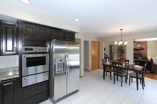 413 West Willow Road Prospect Heights, IL 60070 - Photo 8 of 20 a kitchen with granite countertop a refrigerator stove dining table and chairs