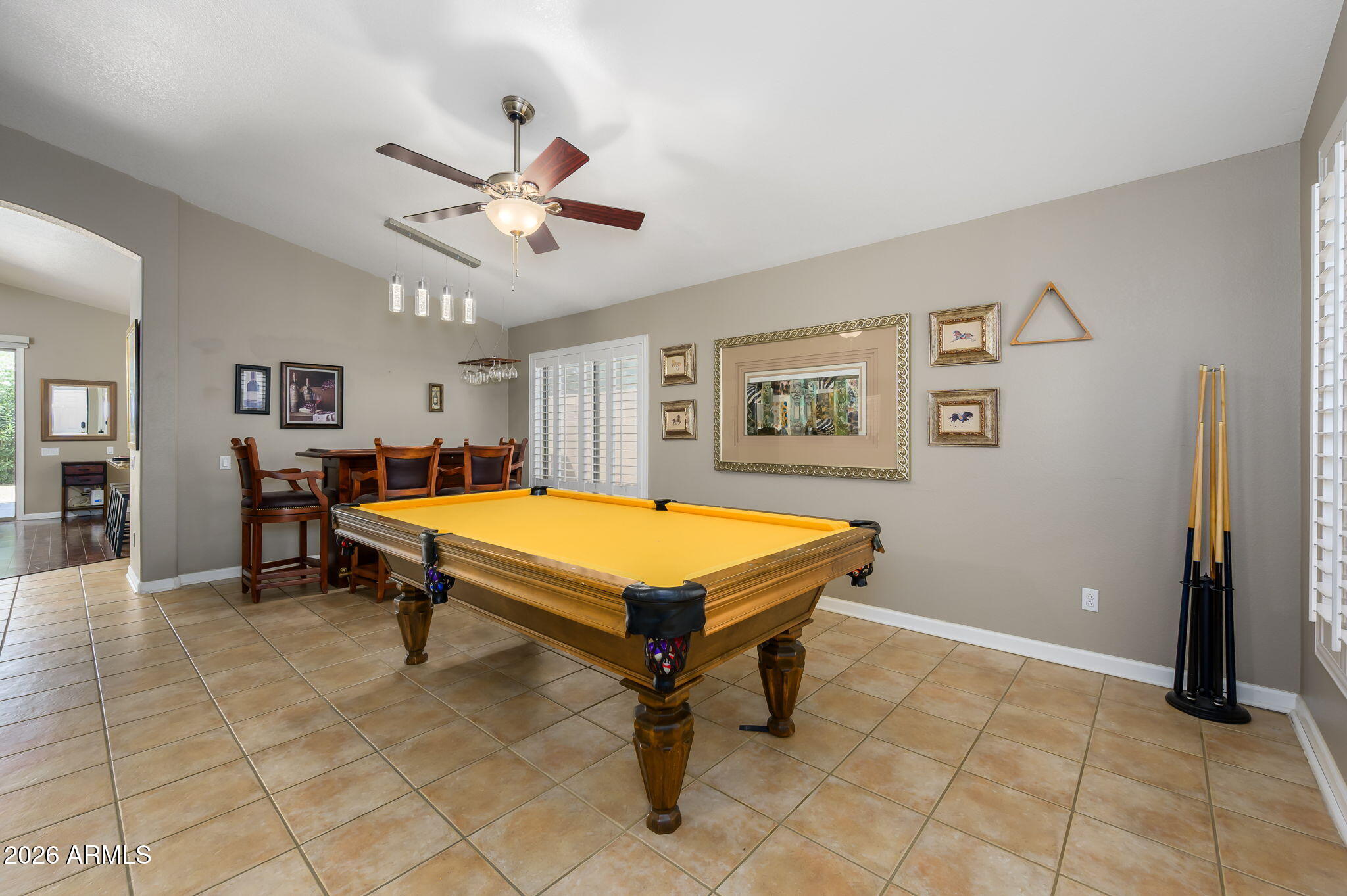 3136 East Roveen Avenue Phoenix, AZ 85032 - Photo 5 of 38 a living room with pool table and a ceiling fan
