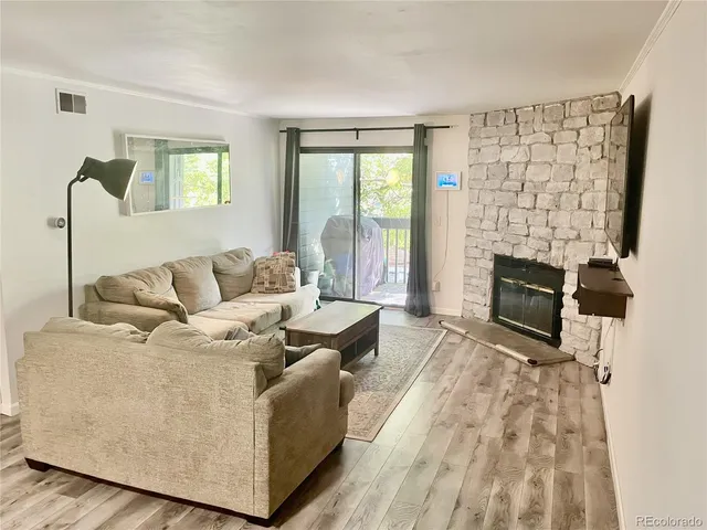 a living room with furniture a flat screen tv and a fireplace
