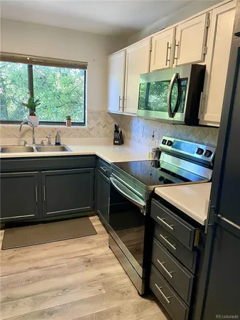 a kitchen with a sink appliances and a window
