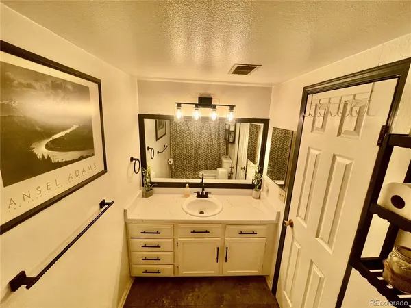 a bathroom with a sink mirror vanity and tub