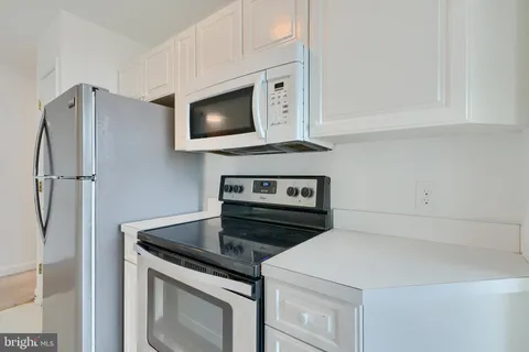 a kitchen with a sink and a refrigerator