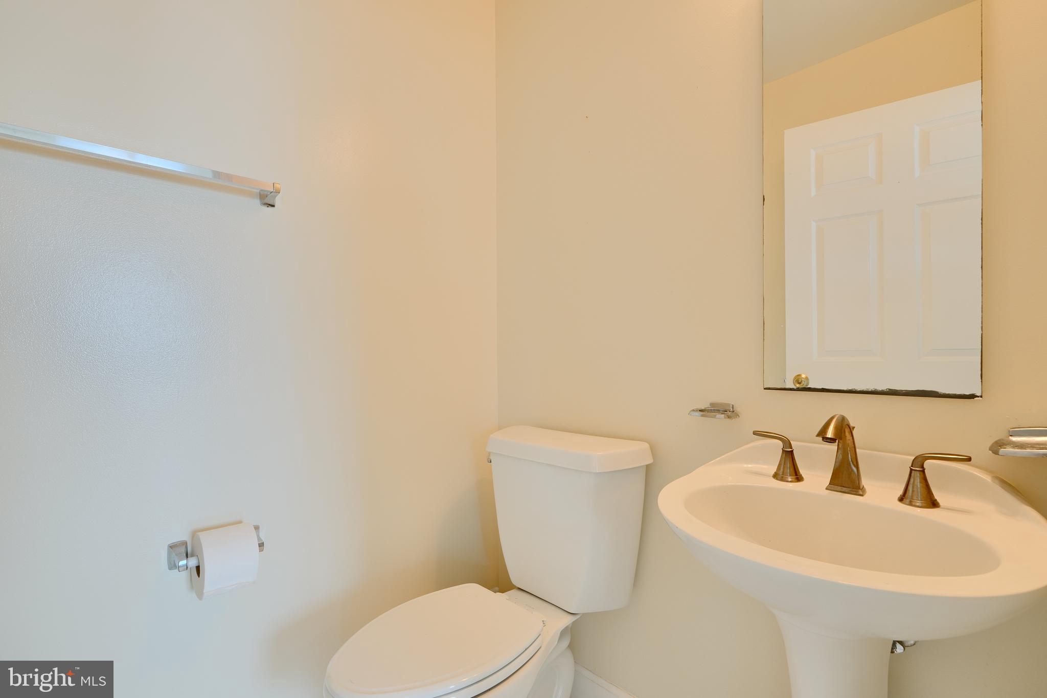 100 Harborview Drive, Unit 609 Baltimore, MD 21230 - Photo 20 of 45 a white toilet sitting next to a bathroom sink