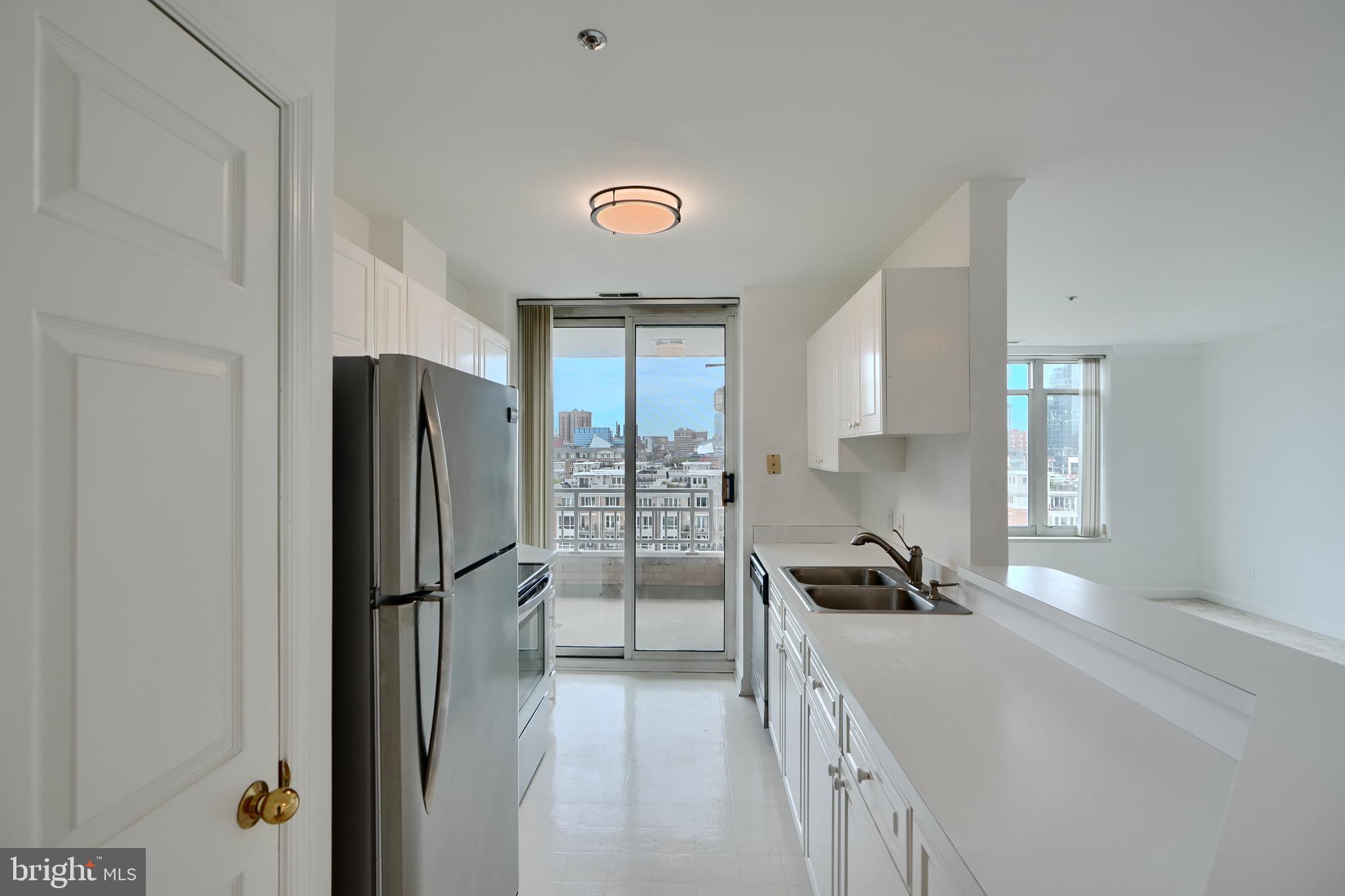 100 Harborview Drive, Unit 609 Baltimore, MD 21230 - Photo 6 of 45 a kitchen with a refrigerator a stove and a sink