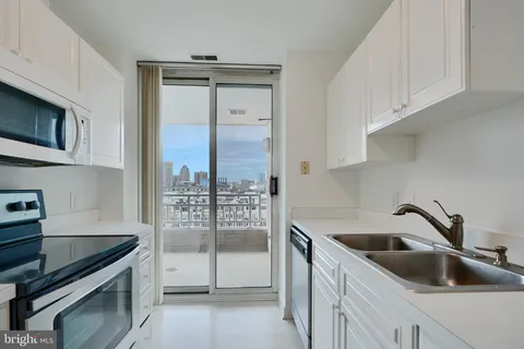 a kitchen with a refrigerator a stove and a sink