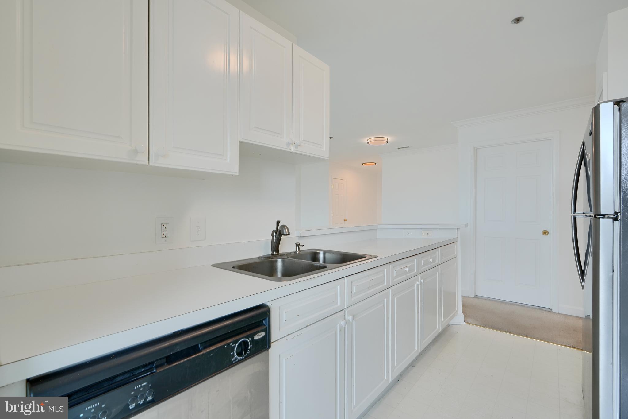100 Harborview Drive, Unit 609 Baltimore, MD 21230 - Photo 8 of 45 a kitchen with a sink and cabinets
