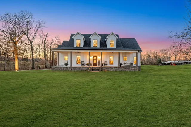 a front view of house with yard and lake view