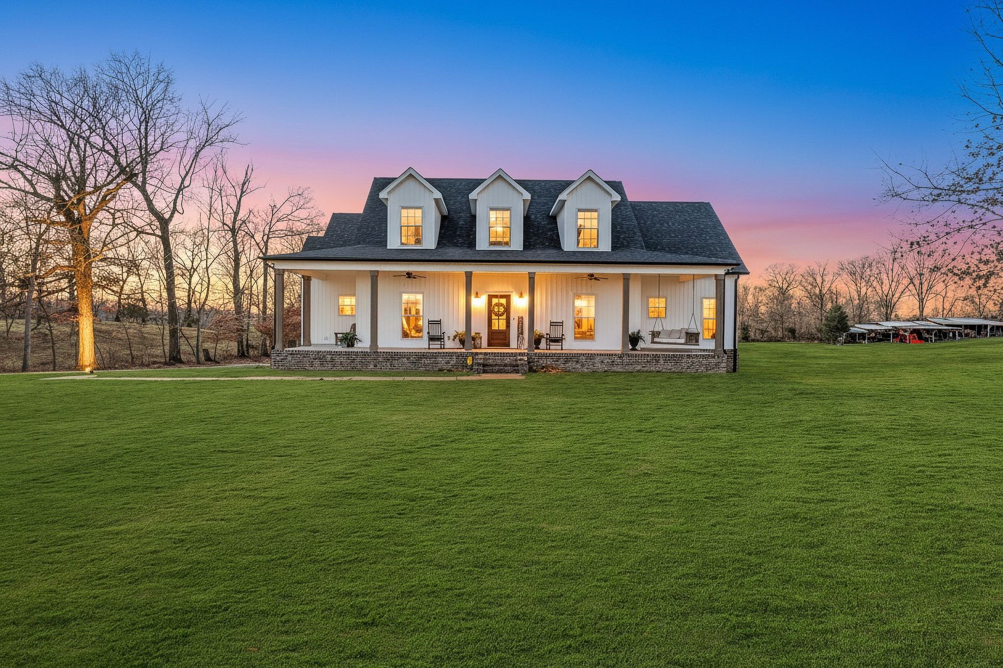 a front view of house with yard and lake view