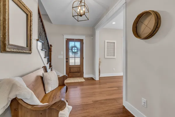 a view of an entryway with wooden floor
