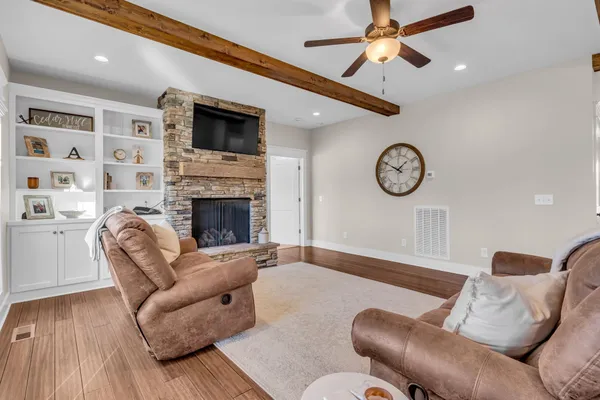 a large kitchen with stainless steel appliances granite countertop a lot of counter space and wooden floors