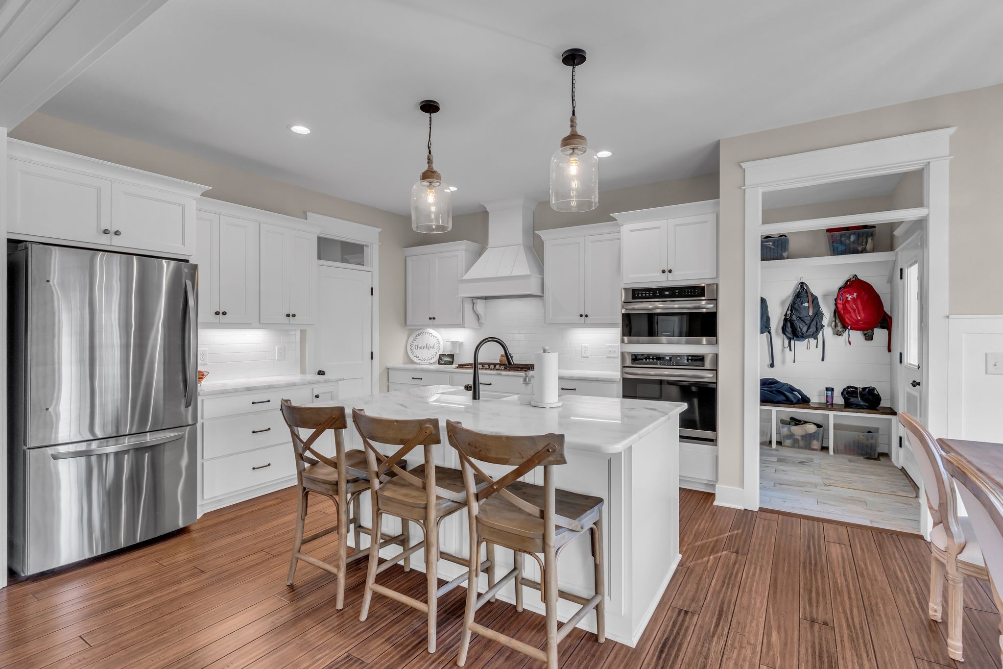 5574 Dowlen Road Cedar Hill, TN 37032 - Photo 17 of 59 a kitchen with stainless steel appliances kitchen island granite countertop a table chairs and a refrigerator