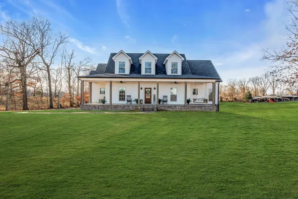 a view of house with a big yard