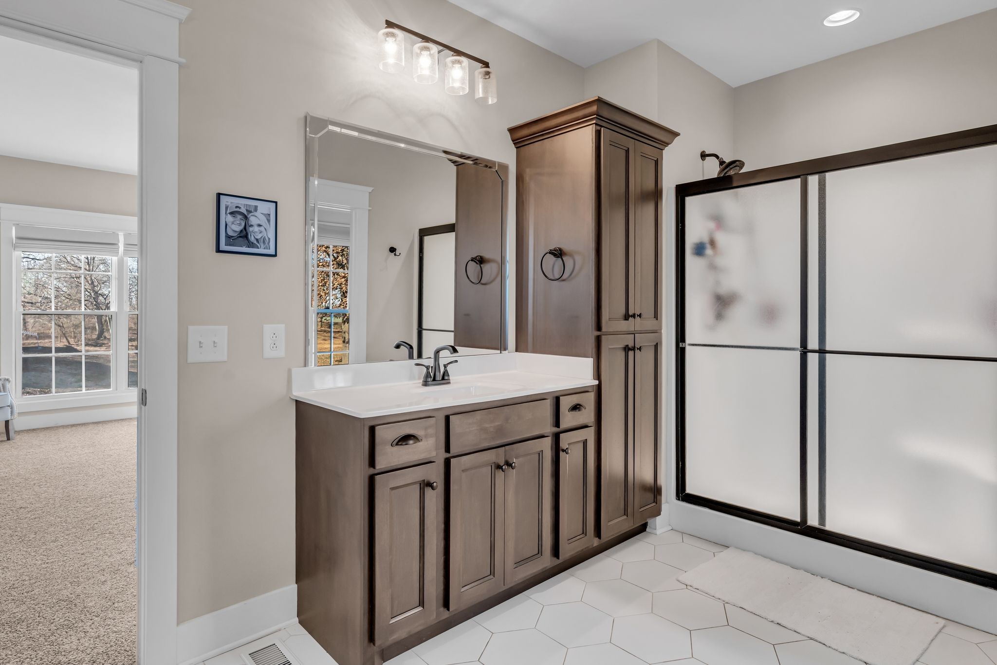 5574 Dowlen Road Cedar Hill, TN 37032 - Photo 28 of 59 a bathroom with a sink mirror and a shower