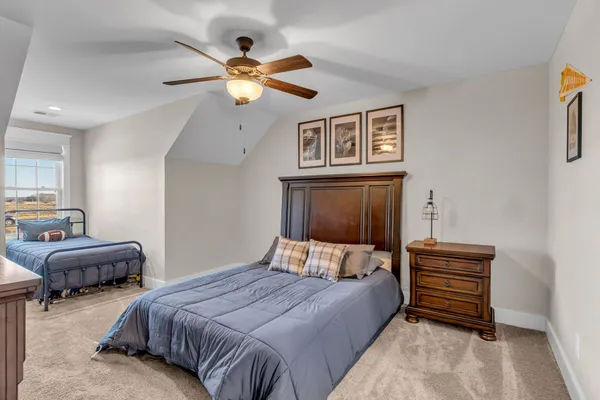 a bedroom with furniture and a chandelier