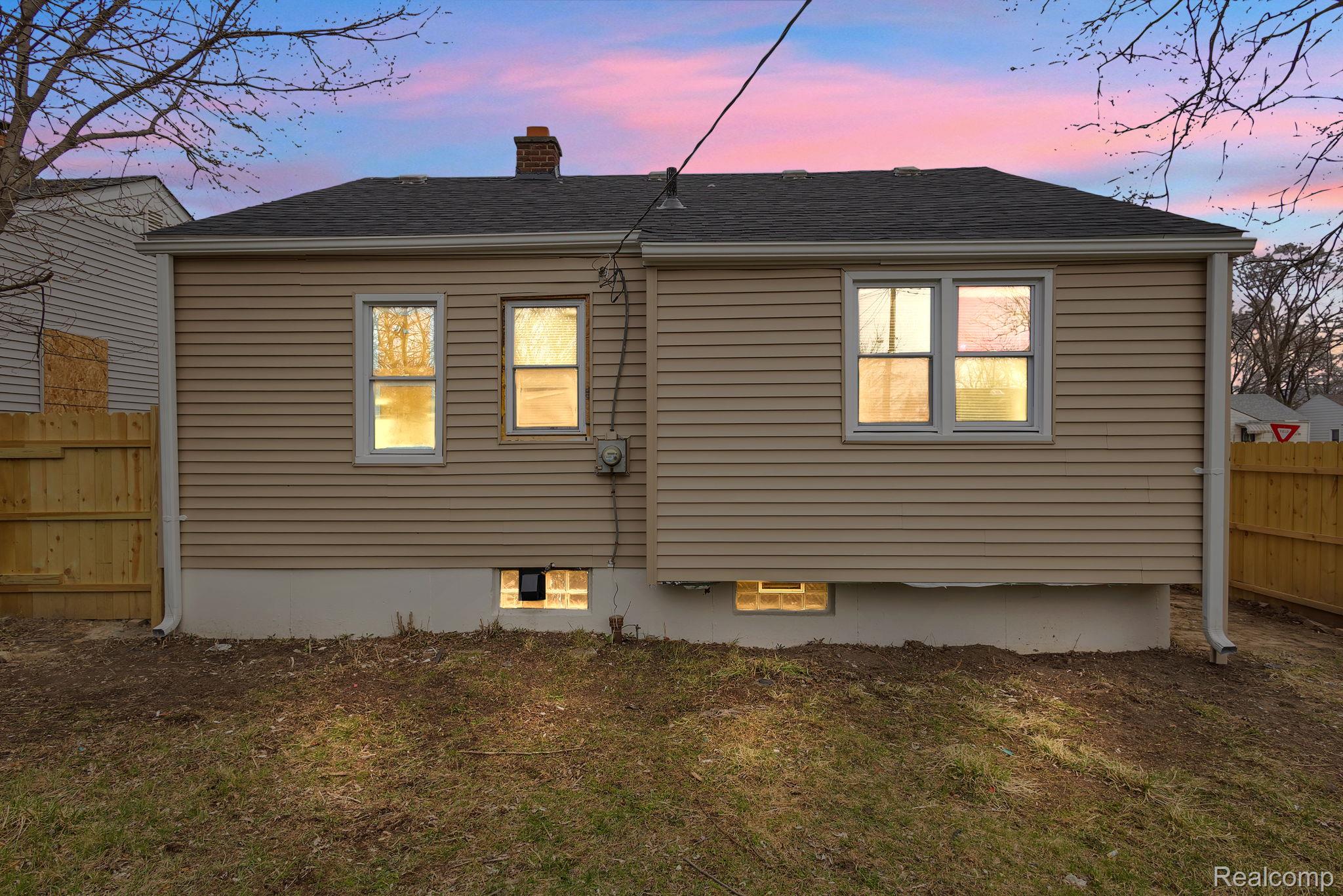 8401 Fielding Street Detroit, MI 48228 - Photo 25 of 34 Rear view of house with a chimney and a shingled roof