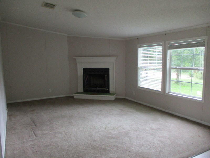 1901 Sexton Road DeFuniak Springs, FL 32433 - Photo 4 of 16 an empty room with a fireplace