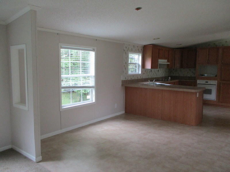 1901 Sexton Road DeFuniak Springs, FL 32433 - Photo 5 of 16 a kitchen with stainless steel appliances granite countertop a sink a stove a refrigerator cabinets and a window