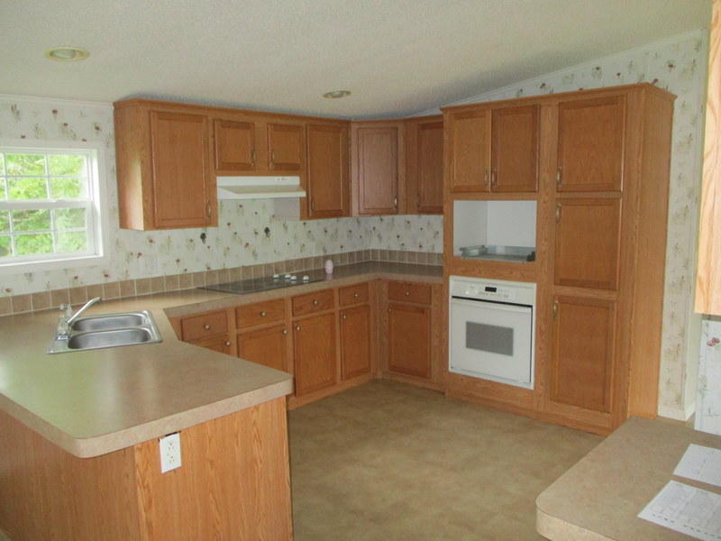 1901 Sexton Road DeFuniak Springs, FL 32433 - Photo 6 of 16 a kitchen with a sink stove and cabinets