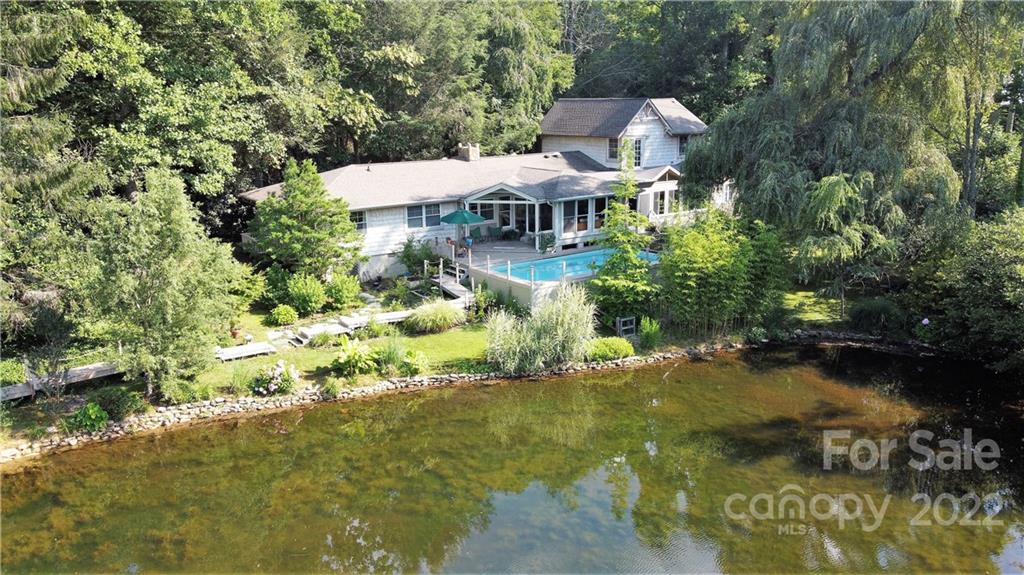 a view of a garden with a table and chairs under an umbrella