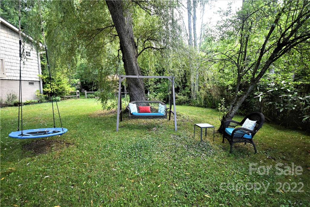 11 Echo Lake Drive Fairview, NC 28730 - Photo 11 of 48 a backyard of a house with table and chairs