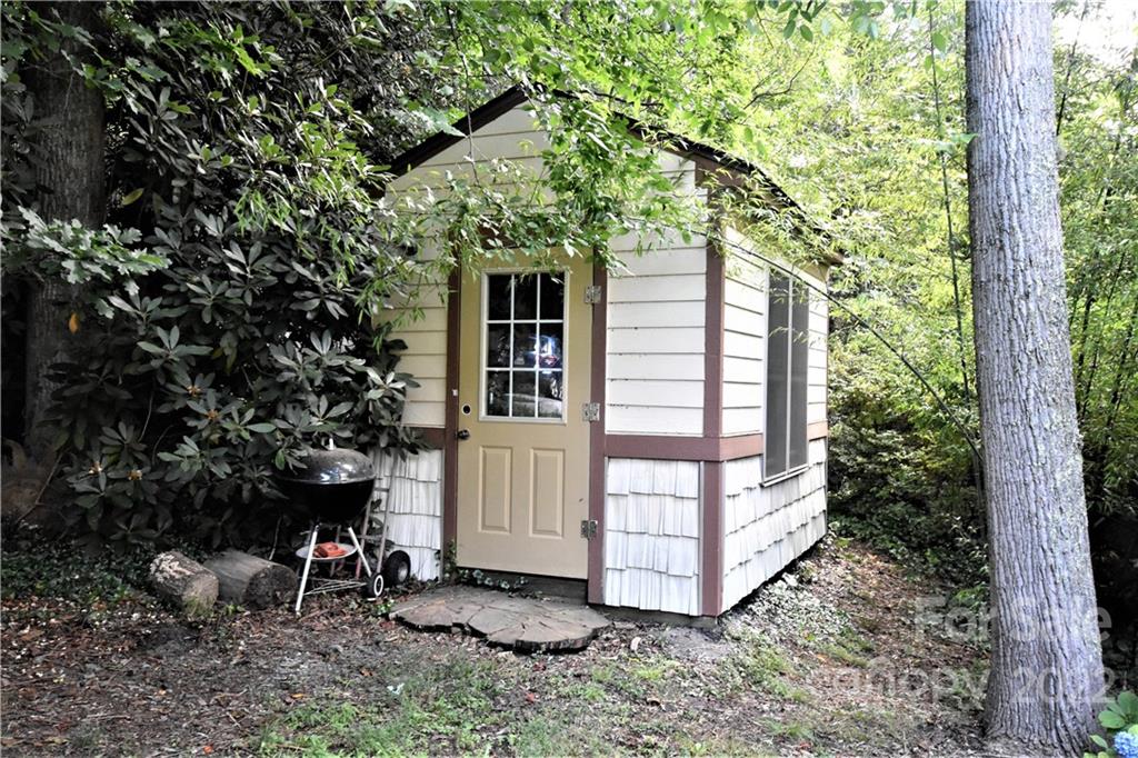 11 Echo Lake Drive Fairview, NC 28730 - Photo 14 of 48 a view of a chair and table in the backyard