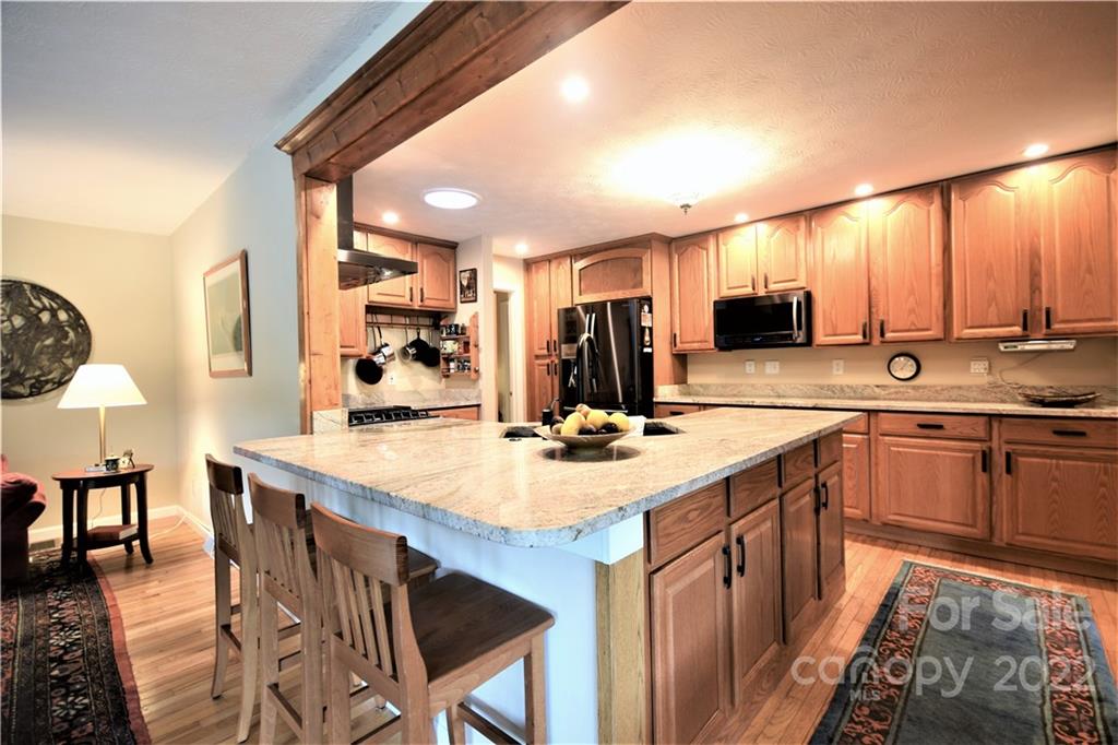 11 Echo Lake Drive Fairview, NC 28730 - Photo 21 of 48 a kitchen with kitchen island granite countertop a sink appliances and cabinets